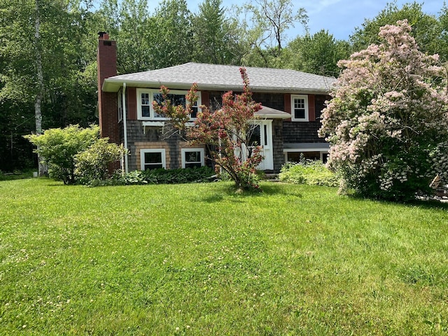 363 Oak Point Rd, Trenton, ME 04605 - split foyer home featuring a chimney and a front yard