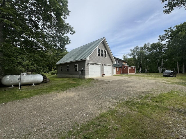 71 Garland Rd, Dixmont, ME 04932 - view of home's exterior with driveway and a metal roof