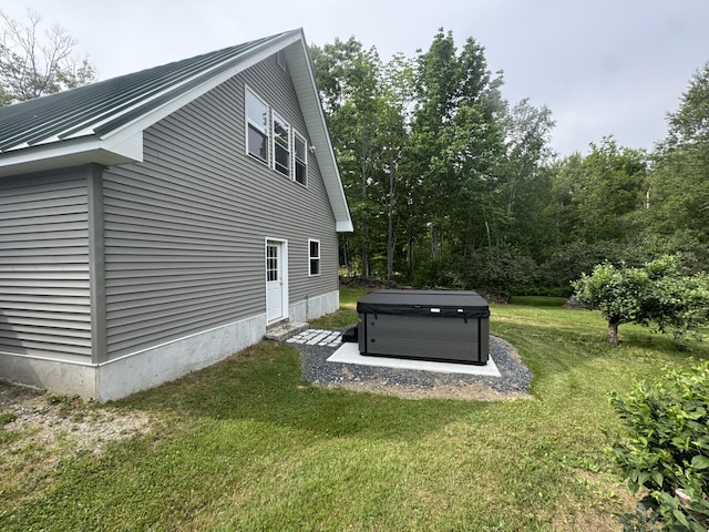 71 Garland Rd, Dixmont, ME 04932 - view of side of property with a hot tub, a lawn, a metal roof, and a standing seam roof