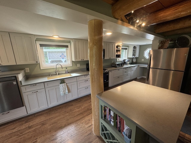 71 Garland Rd, Dixmont, ME 04932 - kitchen featuring freestanding refrigerator, dishwashing machine, beamed ceiling, open shelves, and dark wood-style flooring