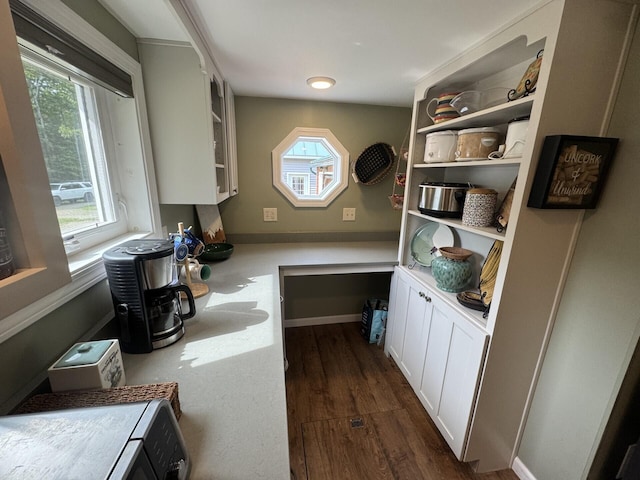 71 Garland Rd, Dixmont, ME 04932 - kitchen featuring dark wood-type flooring, plenty of natural light, glass insert cabinets, and built in study area
