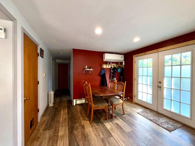 520 W Shore Rd, Sorrento, ME 04677 - dining room with french doors, wood finished floors, an AC wall unit, a baseboard radiator, and recessed lighting