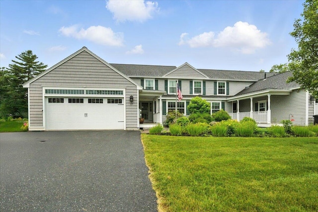17 Beryl Loop Unit F65, Topsham, ME 04086 - view of front of house featuring an attached garage, asphalt driveway, and a front lawn