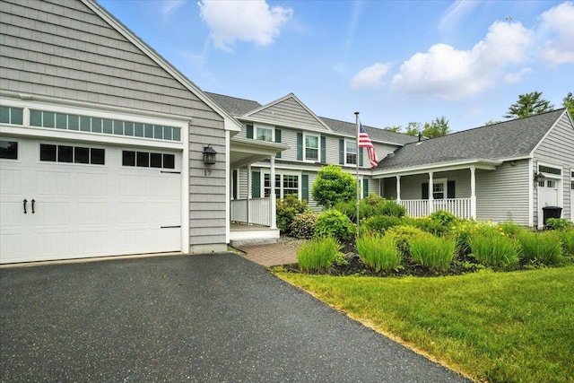 17 Beryl Loop Unit F65, Topsham, ME 04086 - view of front of house featuring an attached garage, a porch, driveway, and a front lawn