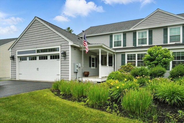 17 Beryl Loop Unit F65, Topsham, ME 04086 - view of front facade with a garage, asphalt driveway, and covered porch