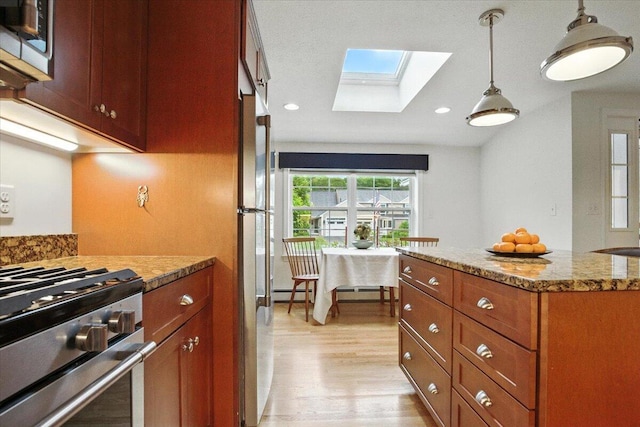 17 Beryl Loop Unit F65, Topsham, ME 04086 - kitchen featuring a skylight, light wood-style floors, pendant lighting, brown cabinets, and appliances with stainless steel finishes
