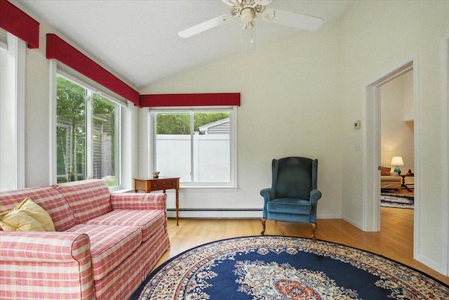 17 Beryl Loop Unit F65, Topsham, ME 04086 - living room featuring baseboard heating, wood finished floors, lofted ceiling, and a ceiling fan