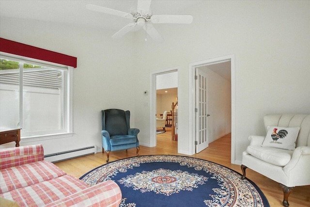 17 Beryl Loop Unit F65, Topsham, ME 04086 - living area featuring baseboard heating, wood finished floors, and a ceiling fan