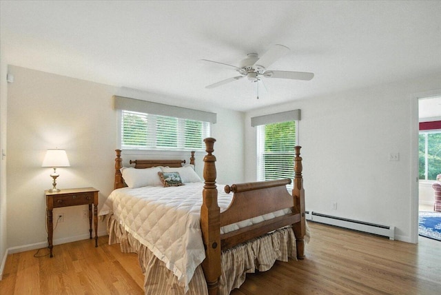 17 Beryl Loop Unit F65, Topsham, ME 04086 - bedroom with a baseboard radiator, multiple windows, light wood-type flooring, and a ceiling fan