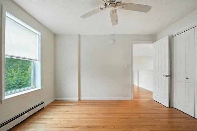 17 Beryl Loop Unit F65, Topsham, ME 04086 - unfurnished bedroom with a baseboard heating unit, light wood-style floors, a closet, and a ceiling fan