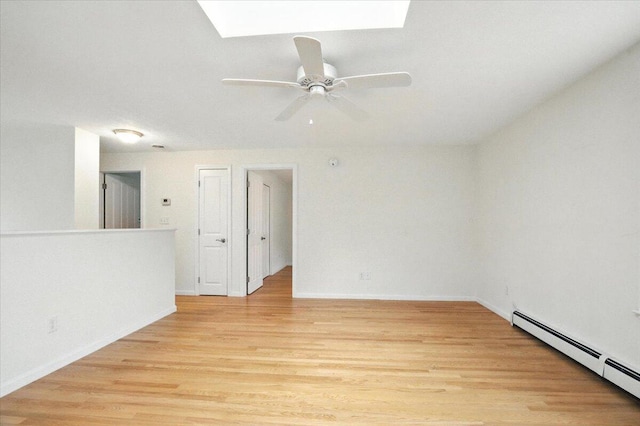 17 Beryl Loop Unit F65, Topsham, ME 04086 - spare room with a skylight, a baseboard heating unit, light wood-style floors, and a ceiling fan