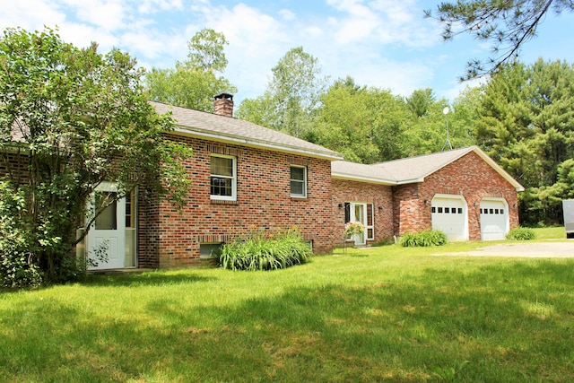 94 Blaisdell Rd, Newport, ME 04953 - view of front of property featuring a chimney, brick siding, a front yard, and a garage