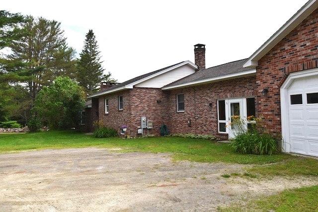 94 Blaisdell Rd, Newport, ME 04953 - view of property exterior featuring a chimney, brick siding, and a yard