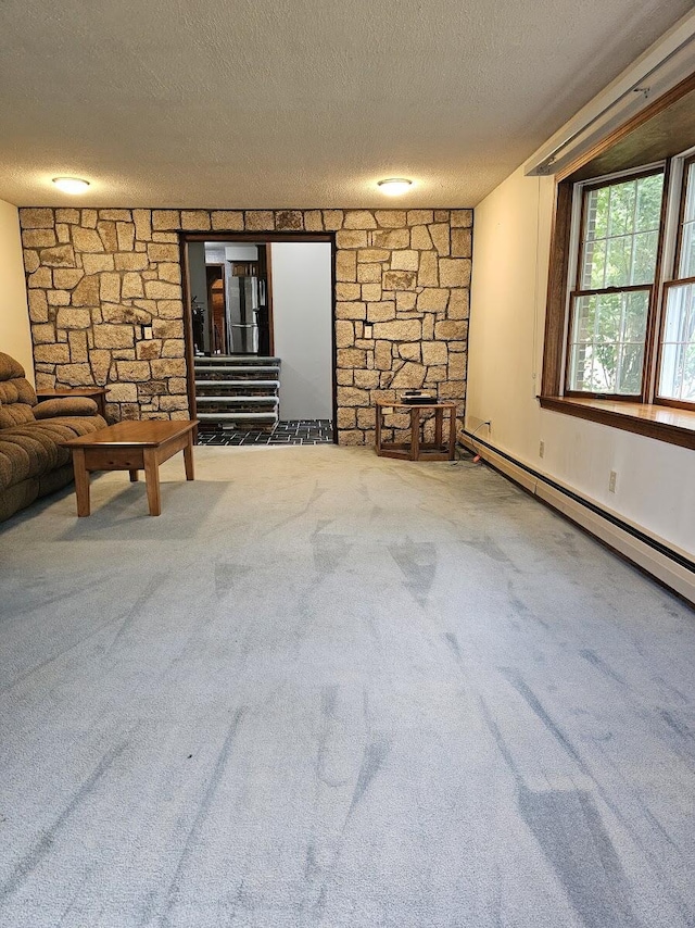 94 Blaisdell Rd, Newport, ME 04953 - unfurnished living room with baseboard heating, a textured ceiling, and carpet