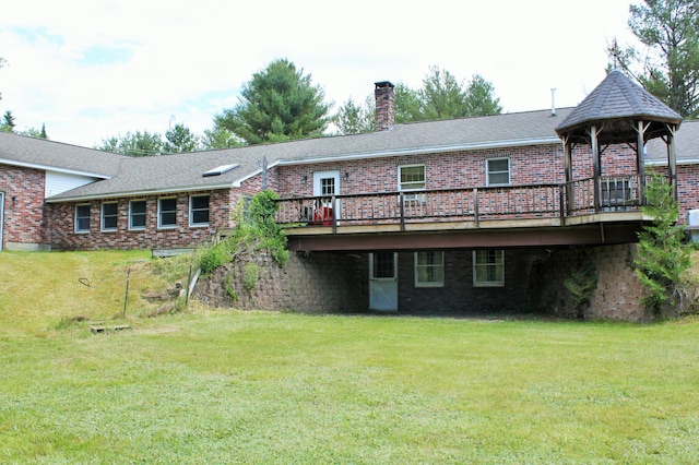 94 Blaisdell Rd, Newport, ME 04953 - rear view of house featuring brick siding, a wooden deck, and a yard