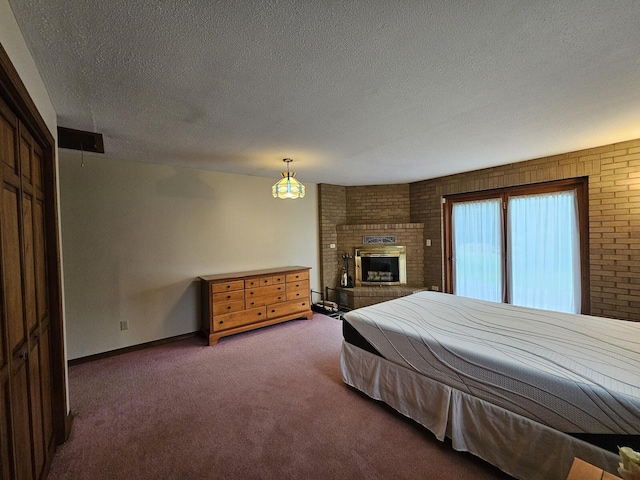 94 Blaisdell Rd, Newport, ME 04953 - bedroom with carpet flooring, a textured ceiling, and a fireplace