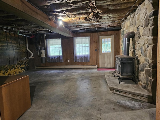 94 Blaisdell Rd, Newport, ME 04953 - basement featuring a wood stove, baseboard heating, and wood walls