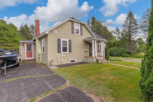 736 Webster St, Lewiston, ME 04240 - bungalow-style house featuring a front yard and a chimney