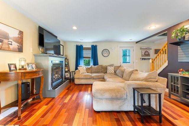 736 Webster St, Lewiston, ME 04240 - living area with stairway, hardwood / wood-style flooring, a fireplace with raised hearth, and recessed lighting
