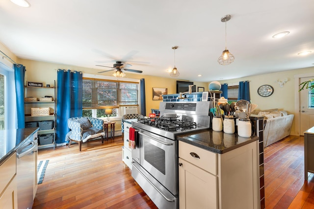 736 Webster St, Lewiston, ME 04240 - kitchen with stainless steel appliances, open floor plan, light wood-type flooring, ceiling fan, and decorative light fixtures