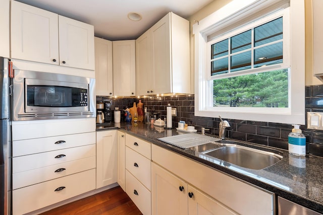 736 Webster St, Lewiston, ME 04240 - kitchen with stainless steel appliances, backsplash, dark wood finished floors, and dark stone countertops