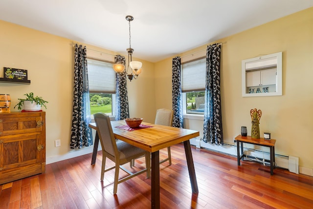 736 Webster St, Lewiston, ME 04240 - dining area featuring a chandelier, plenty of natural light, hardwood / wood-style flooring, and a baseboard radiator