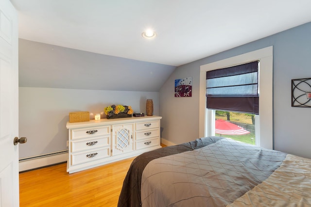 736 Webster St, Lewiston, ME 04240 - bedroom with a baseboard heating unit, vaulted ceiling, wood finished floors, and recessed lighting