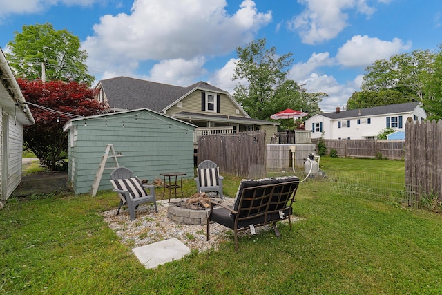 736 Webster St, Lewiston, ME 04240 - view of yard featuring a fire pit and a storage unit