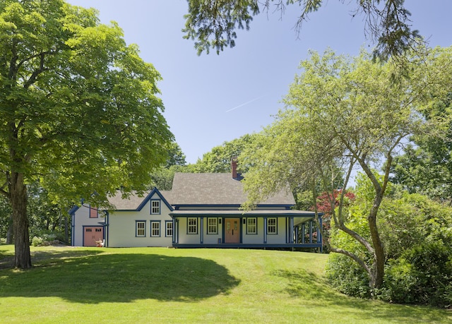 239 Ocean Point Rd, Boothbay, ME 04544 - view of front of home with covered porch, a front yard, a chimney, an attached garage, and roof with shingles