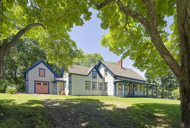 239 Ocean Point Rd, Boothbay, ME 04544 - view of front of house with a chimney, a front yard, a garage, and roof with shingles