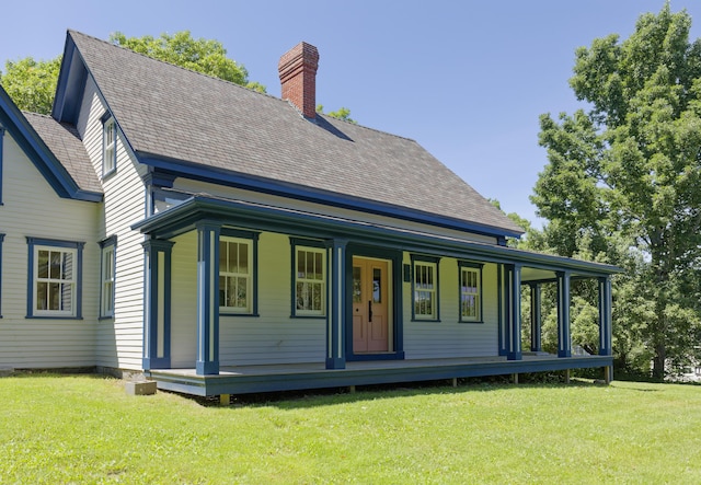 239 Ocean Point Rd, Boothbay, ME 04544 - back of house featuring a chimney, covered porch, and a yard