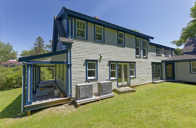 239 Ocean Point Rd, Boothbay, ME 04544 - rear view of house with french doors, a lawn, a deck, and a chimney