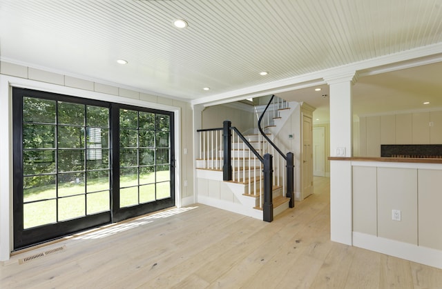 239 Ocean Point Rd, Boothbay, ME 04544 - foyer with light wood-style floors, stairs, ornamental molding, recessed lighting, and ornate columns