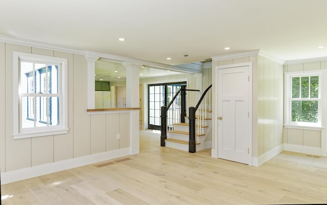 239 Ocean Point Rd, Boothbay, ME 04544 - spare room with light wood-style flooring, plenty of natural light, ornamental molding, stairway, and a decorative wall