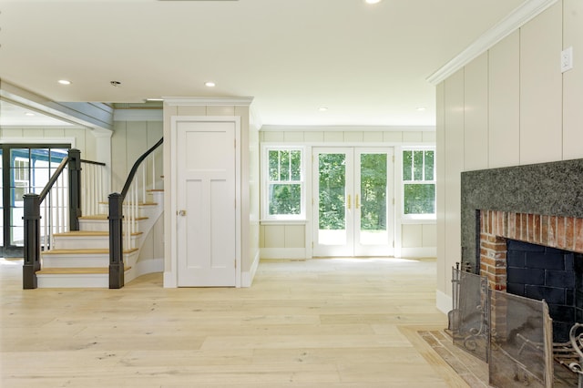 239 Ocean Point Rd, Boothbay, ME 04544 - stairway with french doors, a fireplace, crown molding, wood finished floors, and recessed lighting