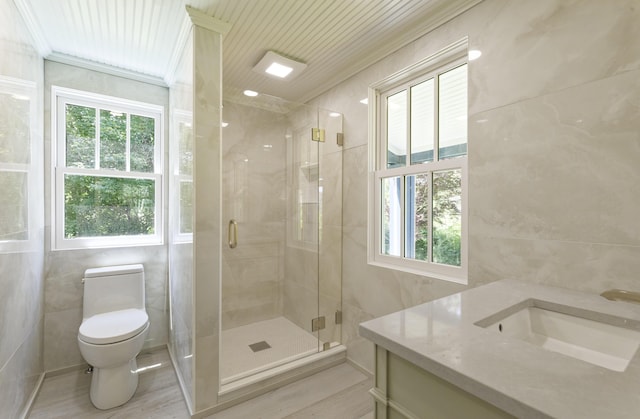 239 Ocean Point Rd, Boothbay, ME 04544 - bathroom featuring tile walls, vanity, a shower stall, and crown molding