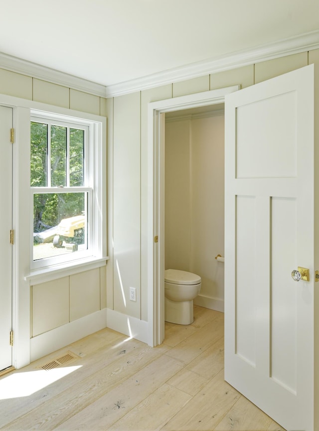 239 Ocean Point Rd, Boothbay, ME 04544 - bathroom with wood-type flooring and crown molding