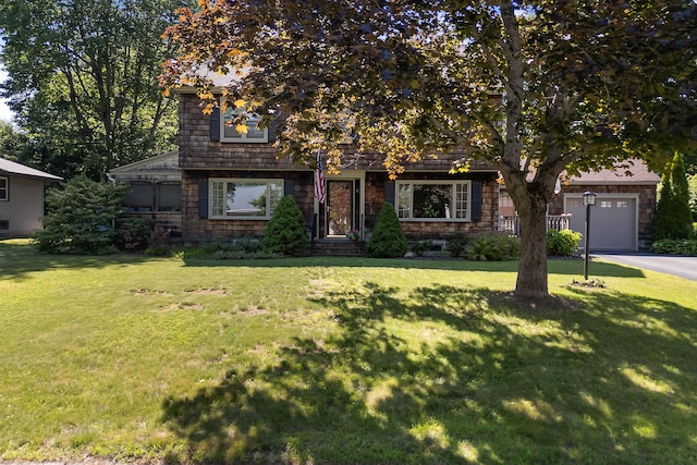 36 Woodlawn Ave, Auburn, ME 04210 - view of front of house with an attached garage, a front lawn, and asphalt driveway