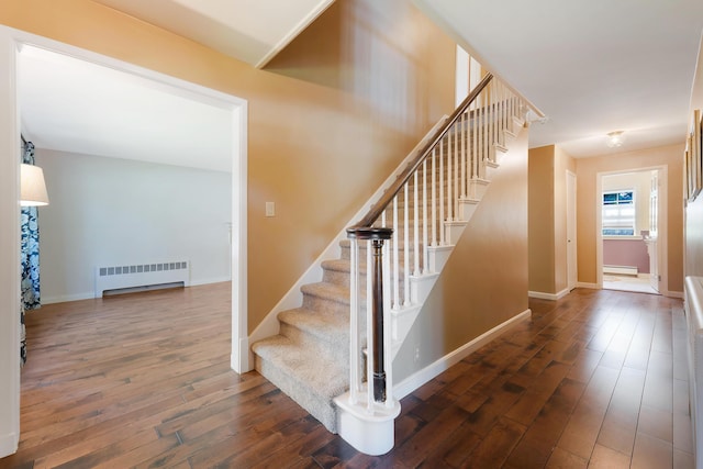 36 Woodlawn Ave, Auburn, ME 04210 - stairs featuring radiator heating unit, wood-type flooring, and a baseboard radiator