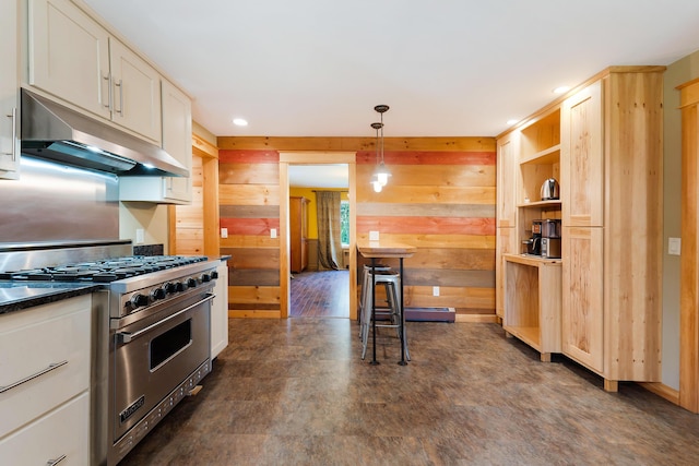 36 Woodlawn Ave, Auburn, ME 04210 - kitchen featuring premium range, under cabinet range hood, wood walls, recessed lighting, and dark countertops