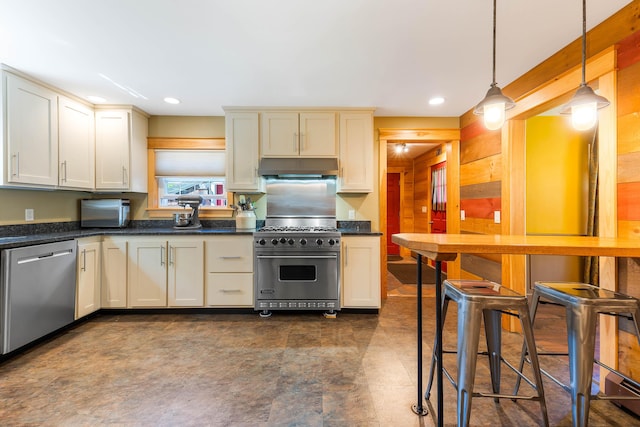 36 Woodlawn Ave, Auburn, ME 04210 - kitchen with stainless steel appliances, under cabinet range hood, decorative light fixtures, recessed lighting, and wooden walls
