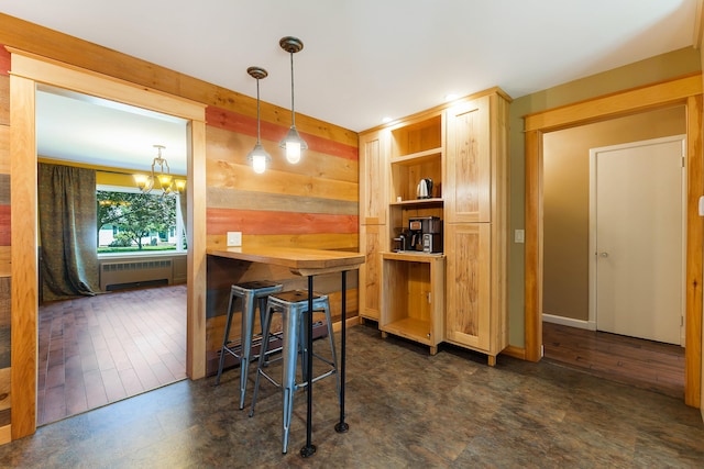 36 Woodlawn Ave, Auburn, ME 04210 - dining area with radiator heating unit, a chandelier, and wooden walls