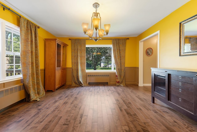 36 Woodlawn Ave, Auburn, ME 04210 - unfurnished dining area featuring radiator heating unit, a chandelier, healthy amount of natural light, and wainscoting