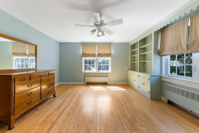 36 Woodlawn Ave, Auburn, ME 04210 - bedroom with radiator heating unit, multiple windows, and light wood-style floors
