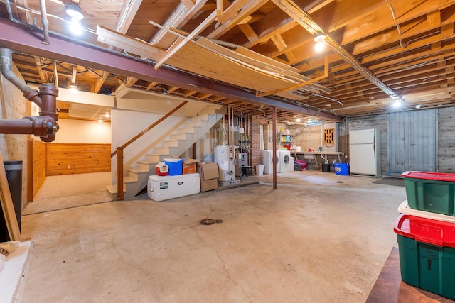 36 Woodlawn Ave, Auburn, ME 04210 - unfinished below grade area with freestanding refrigerator, gas water heater, stairs, and washer and dryer