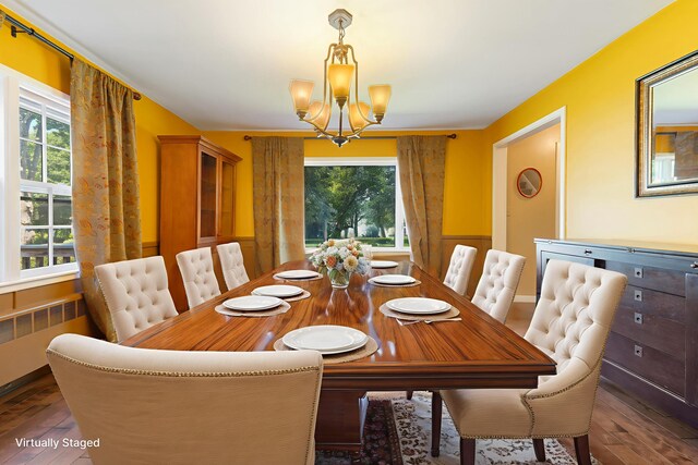 36 Woodlawn Ave, Auburn, ME 04210 - dining room featuring radiator heating unit, a chandelier, and wood-type flooring