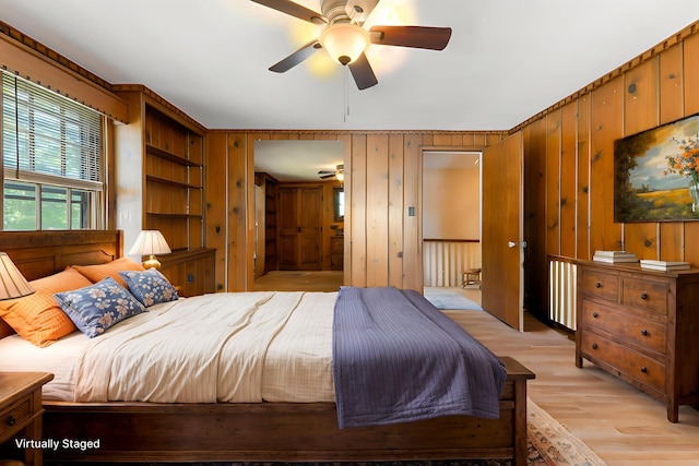 36 Woodlawn Ave, Auburn, ME 04210 - bedroom featuring light wood finished floors, wooden walls, and a ceiling fan