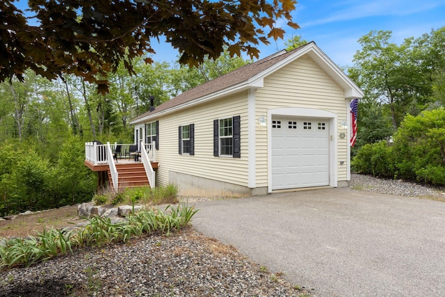 1313 Deer Run, Casco, ME 04015 - view of front of home with a wooden deck, a garage, driveway, and roof with shingles