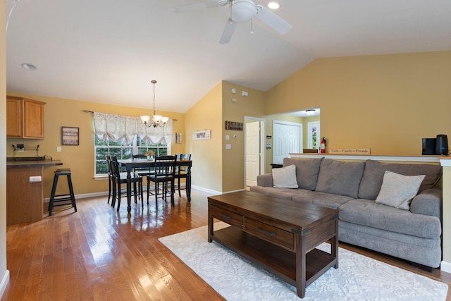 1313 Deer Run, Casco, ME 04015 - living area with a chandelier, light wood-type flooring, a ceiling fan, and high vaulted ceiling