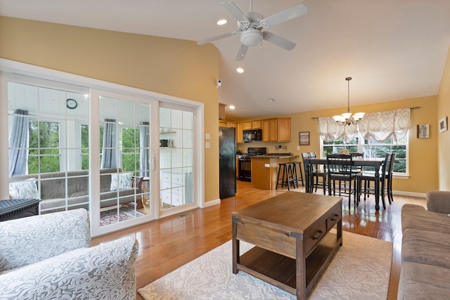 1313 Deer Run, Casco, ME 04015 - living area featuring lofted ceiling, a chandelier, a ceiling fan, light wood finished floors, and recessed lighting
